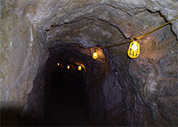 Today the tunnels have electric lights strung overhead; in the old days, miners did their work using candles and lanterns.