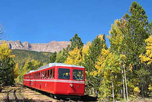 The Pikes Peak Cog Railway passes through colorful golden-hued aspen groves on an Indian Summer day in fall.