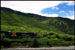 [A train chugs through Glenwood.]